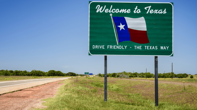 Welcome to Texas road sign symbolizing migration and population growth driving Texas real estate demand